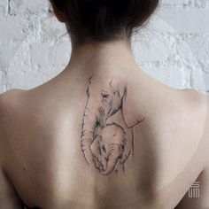 a woman with a tattoo on her back