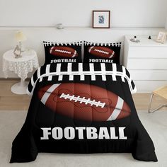 a bed with a football comforter and pillows