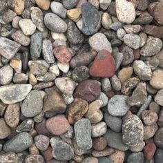 rocks and gravel are arranged together on the ground