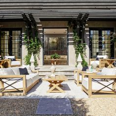 an outdoor seating area with wooden furniture and potted plants