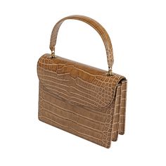 Isabella is presented in the finest brown authentic alligator leather, making it the perfect choice for formal events. This upscale handbag features high-quality Cafe Glossy alligator leather for the main body, gussets, back body, top flap, handle, bottom, vistas, and pouch, offering a luxurious and cohesive texture. Handcrafted by generational artisans, Isabella exemplifies meticulous craftsmanship and timeless elegance, ensuring that it stands out in any setting. The rich Cafe Glossy alligator leather provides a sophisticated and exotic look, while the sturdy handle blends style and functionality effortlessly. Luxury Crocodile Pattern Shoulder Bag For Formal Occasions, Luxury Crocodile Pattern Shoulder Bag For Formal Events, Formal Crocodile Pattern Rectangular Shoulder Bag, Formal Rectangular Bag With Crocodile Pattern, Classic Brown Evening Bag With Top Handle, Formal Satchel With Crocodile Pattern And Top Handle, Luxury Brown Evening Bag With Detachable Handle, Formal Top Handle Satchel With Crocodile Pattern, Timeless Formal Bag With Crocodile Pattern