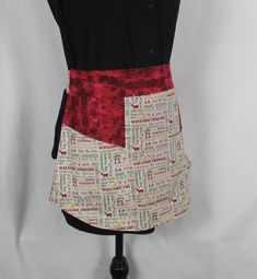 a mannequin wearing a red and white skirt with words all over it's sides