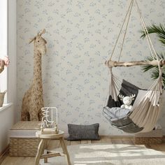 a child's room with a giraffe wallpaper and hammock chair