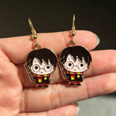 a pair of earrings featuring a cartoon character