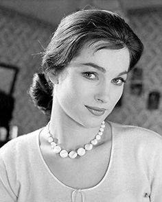 black and white photograph of a woman wearing a pearl necklace