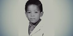 a black and white photo of a young boy