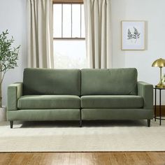 a living room scene with focus on the couch and window in the backround