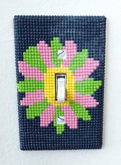 a light switch cover with flowers painted on it