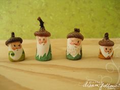 four little gnomes are sitting on a table