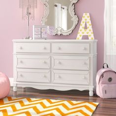 This 6-drawer double dresser offers extra storage space in your little one's bedroom or play space. The frame is crafted from solid wood with a crisp white finish, and it rests on carved, spindle legs for a traditional look. Six dovetailed drawers open on ball-bearing glides, revealing room for reading glasses, books, and other bedside essentials. We love how the shiplap paneling, crown molding, and curtained apron on the bottom give this piece plenty of vintage-inspired charm. Plus, this dresse Dresser Brown, 8 Drawer Dresser, 7 Drawer Dresser, 4 Drawer Dresser, 9 Drawer Dresser, Box Spring Bed, Garden Table And Chairs, Wooden Knobs, Double Dresser