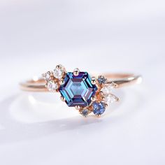 a blue and white diamond ring on a white surface