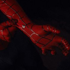 a spider - man costume is shown in the dark with his hands extended out to show it's claws