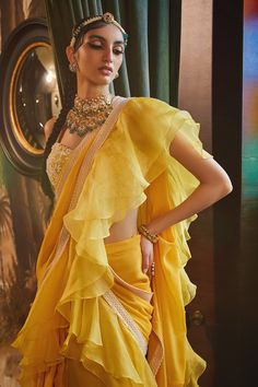 Mango pre-stitched saree with ruffle detail and embroidered border. Paired with floral embroidered blouse.
Component: 2
Embroidered
Neckline: Sweetheart
Sleeve Length: Sleeveless
Fabric: Georgette,Organza
Color: Yellow
Tassel straps
Sequin, pearl and cutdana work - Aza Fashions Ruffled Saree, Indian Bridesmaids, Blouse Yoke, Ruffle Saree, Drape Saree, Indian Couture, Sanya, Embroidered Neckline, Fashion Attire