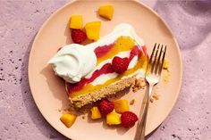 there is a piece of cake with fruit on it and a fork next to it