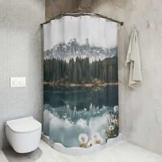 a bathroom with a shower curtain that has a mountain lake in the middle and trees on the other side