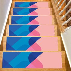 the stair treads are painted with blue and pink shapes