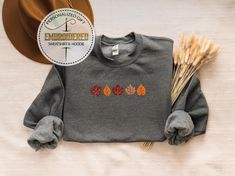 Embroidered Fall Leaves Sweatshirt, Cute Fall Shirt, Autumn Leaves Embroidery Shirt, Cute Fall Foliage Sweatshirt, Embroidered Sweatshirt ---------- Product ---------- * Heather CVC Colors: 50% cotton, 50% poly, * Plain colors:100% cotton * Rolled sleeves in pictures is for styling purposes only. * Colors may seem different on the computer screen, or in the lighting in which the picture was taken. * Each item is sold separately. * Double-needle stitching throughout * Seamless collar * We use direct to film printing method * Taped shoulder-to-shoulder * Due to stock availability problem we may make your t-shirts with different brand. -----How To Order----- 1-) Please, check and review all photos 2-) Choose your t-shirt size and color *Different styles of shirts may have different shades of Shirt Embroidery, Embroidered Sweatshirts, Fall Shirts, Fall Foliage, Different Styles, Color Matching, Autumn Leaves, Sweatshirts Hoodie, Adult Outfits