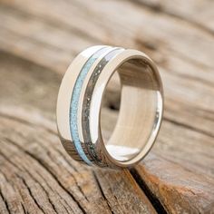 a wedding ring that has been made with wood and blue inlays on it