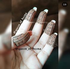 a woman's hand with an intricately designed manicure on her fingers and nails