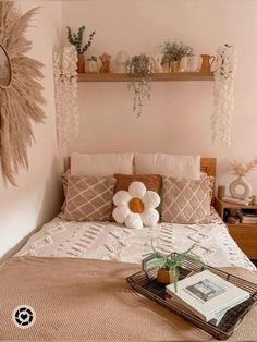 a bed with pillows and flowers on the headboard