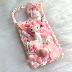 a cell phone case made to look like it is decorated with pink and white items