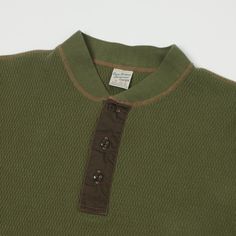 This traditional military thermal layer has been brought to us from the good people at Buzz Rickson’s, and features a 100% cotton construction, and a luxuriously comfortable thermal knit. This unique knit design has been manufactured to trap the body’s natural heat, and use it to your advantage, and it does so perfectly. The slim body shape of this piece allows it to be easily layered up in the winter months, for comfort, effortless style, and warmth. A scalloped hem has been added, along with a Thermal Shirt Aesthetic, Thermal Henley Outfit, Vintage Thermal Shirt, Men’s Henley, Relaxed Fit Henley T-shirt With Button Closure, Henley Tee, Mens Cuts, Scalloped Hem, Knit Shirt