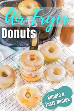 glazed donuts sitting on top of a cooling rack next to an air fryer