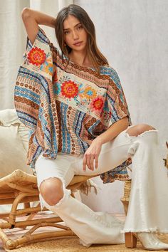 Floral Poncho Top This Woven Poncho Top features delicate floral embroidery across the front. The neckline is round and the fit is flowy and loose, making it a comfortable and stylish choice. A S/M fits a bust of 34-36" (a size 4-8) and a M/L fits a bust of 35-38" (a size 6-10). Brand: Savanna Jane Flowy Floral Print Top With Butterfly Sleeves, Flowy Floral Print Blouse With Butterfly Sleeves, Bohemian Tops With Floral Print And Butterfly Sleeves, Bohemian Floral Print Tops With Butterfly Sleeves, Vacation Blouse With Butterfly Sleeves And Floral Print, Printed Flowy Tops With Flutter Sleeves, Flowy Printed Tops With Flutter Sleeves, Flowy Multicolor Flutter Sleeve Tops, Multicolor Flowy Tops With Flutter Sleeve