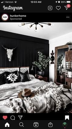 a bed room with a neatly made bed and black walls