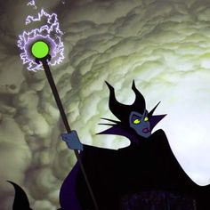 maleficent from the animated movie maleficent is holding a staff and glowing green orb