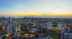 an aerial view of the city at sunset