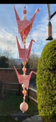 a wind chime hanging from the side of a house