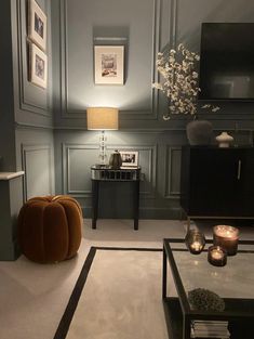 a living room filled with furniture and candles on top of it's coffee table