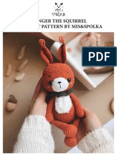 a crocheted stuffed animal in the shape of a rabbit is being held by someone's hand