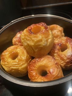 there are many doughnuts in the bowl on the table