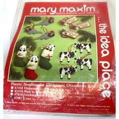 a package of christmas ornaments in the shape of cows and cats on a green background