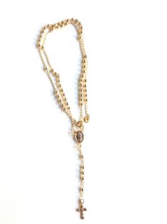 "Catholic Rosary Necklace Gold Beautiful 4mm 18k gold plated round beads and gold plated chain are connected to form this gorgeous Rosary Style necklace. Springring gold filled clasp for closure. In the center of the necklace hangs a gold plated Our Lady of Guadalupe medallion, that finish with a gold plated 0.5\" crucifix, that makes this a different and unique piece. Perfect for everyday wear. Approximate length: 18\" or 45.7 cm. The strand of finish cross measures: 3\" or 7.62cm Total length Spiritual Gold Jewelry With Beaded Chain, Adjustable Gold Cross Pendant Jewelry, Gold Spiritual Jewelry With Beaded Chain, Spiritual Gold Beaded Chain Jewelry, Adjustable Gold Beaded Rosary Bracelet, Gold Rosary Bracelet With Beaded Chain, Spiritual Gold Necklaces With Beaded Chain, Gold Crucifix Rosary For Jewelry Making, Gold Rosary With Beaded Chain As Gift