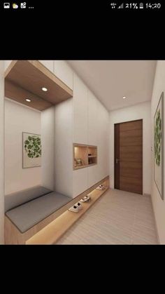 a room with white walls and wood trimmings on the floor, along with a wooden door