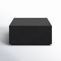 a black box sitting on top of a white floor