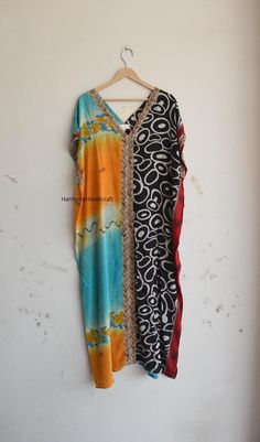 This Kaftan dress Is made From Vintage Silk Sari, Each Sari is Unique And Different. You Cannot Find The Same another one. We Collect The Saree's From Different Villages Of India And Do Customization. These are made with vintage Saree or recycled fabric, So there may be some imperfections Also in that piece you can fine the multi colors spots Dirtiness Al tough when I make these need cut out the imperfect part apart and try to give best part of Saree fabric which is making this totally different Eid Multicolor Block Print Kaftan, Long Patchwork Kaftan, Multicolor V-neck Kaftan With Batik Print, Festive Bohemian Silk Tunic, Bohemian Silk Kaftan For Festive Season, Bollywood Silk Kaftan For Festivals, Long Multicolor Patchwork Kaftan, Multicolor V-neck Kaftan For Navratri, Silk Bohemian Style Kurta For Festivals