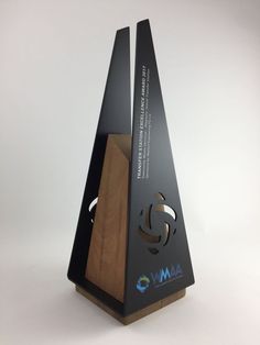 an award is placed on top of a wooden stand with the word amra written below it