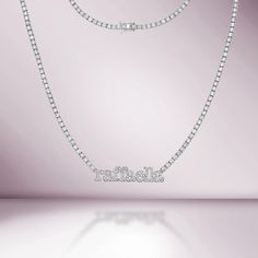 Handmade in New York of polished 14k white gold, CAPUCELLI's  Name Plate Custom Tennis necklace showcases a delicate box chain embellished with dozens of shimmering white diamonds and your choice of lower-cased diamond-set names on a 1.70mm wide diamond tennis necklace. Quality to us is important and that is why we han White Gold Diamond Necklace With Rhinestones, Dazzling White Gold Diamond Necklace With Rhinestones, Diamond Necklaces With Rhinestones, Round Cut, Dazzling White Gold Necklace With Rhinestones, White Gold Cubic Zirconia Necklace With Rhinestones, Classic Diamond Necklace With Rhinestones For Gift, Diamond Tennis Necklace With Rhinestones For Gift, Classic Diamond White Necklace With Rhinestones, White Gold Tennis Necklace With Diamond Accents And Crystal