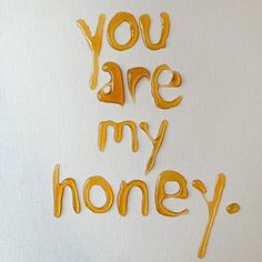 the words you are my honey written in gold paint on a white background with orange and yellow swirls