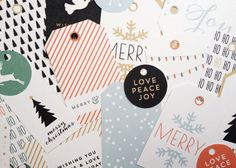 an assortment of christmas stickers and tags on a sheet of paper with the words love, peace, joy