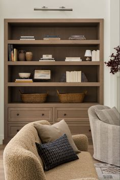 a living room filled with furniture and bookshelves