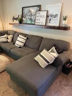 a living room filled with lots of furniture and pillows on top of the couches