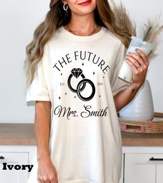 the future mrs smith t - shirt is white with black lettering and two wedding rings on it