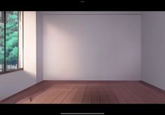 an empty room with wood flooring and a window looking out onto the trees outside