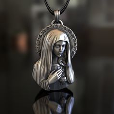 Showcase your devotion with our expertly handcrafted Virgin Mary with Sacred Heart Pendant, made from high-quality 925 Sterling Silver. This unique necklace features a detailed depiction of the Virgin Mary and the Sacred Heart, a profound symbol of divine love and compassion, making it a meaningful accessory for those who appreciate these sacred values. Our skilled artisans have meticulously crafted this pendant to capture the intricate details of this holy image, ensuring that each piece serves Silver Spiritual Virgin Mary Jewelry, Spiritual Silver Jewelry With Virgin Mary, Silver Virgin Mary Pendant Jewelry, The Sacred Heart, Divine Love, Silver Necklaces Women, The Virgin Mary, Gothic Necklace, Unique Necklace