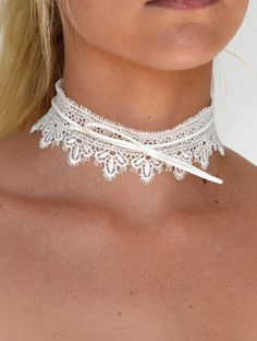 DETAILS: Wide lace choker necklace available in black and white Bow tie detail Bow tie can be adjusted Choker measures approx. 12" length, with a 2" extension 1 3/4" wide Gold plated lobster claw closure Adjustable Lace Choker For Party, Adjustable White Choker For Festival, Elegant White Choker For Festivals, White Choker For Festivals, Elegant White Summer Choker, Elegant White Choker For Summer, White Adjustable Choker Jewelry, Adjustable Lace Trim Choker, White Lace Choker Gift